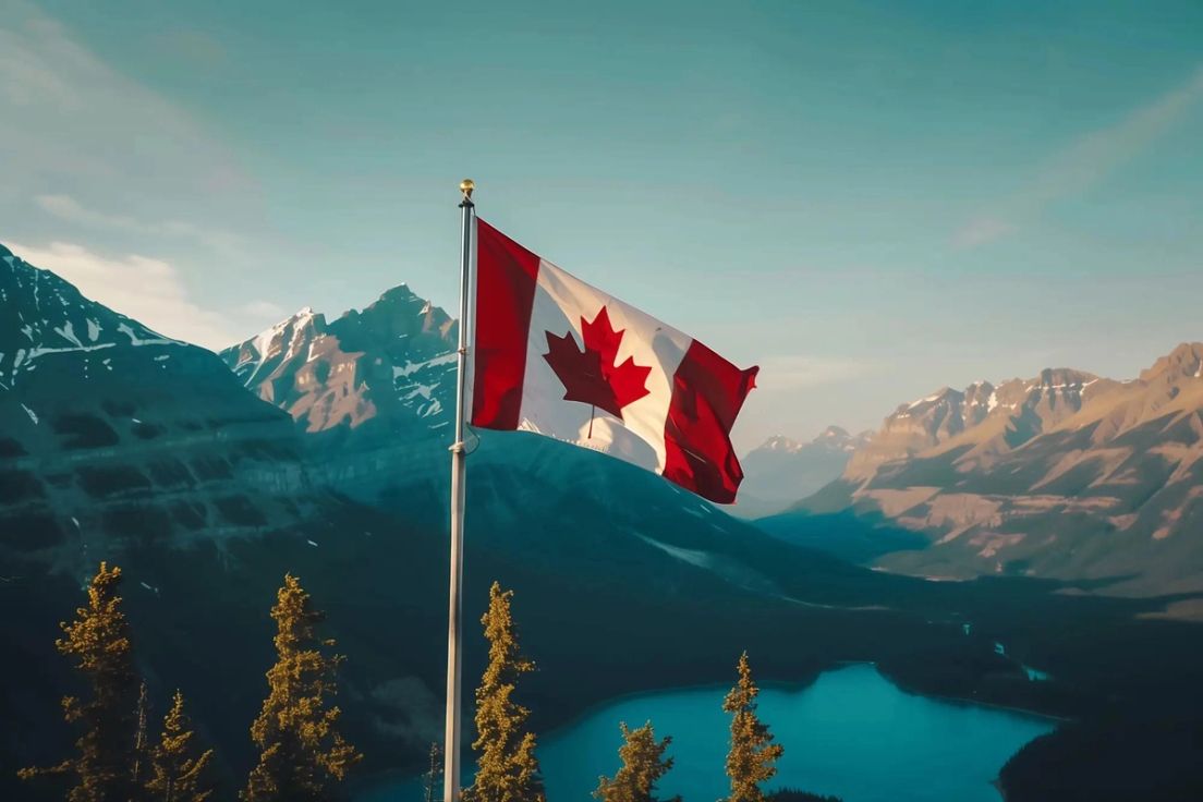 Canadian flag flying over mountains, symbolizing pathways to provincial nomination (PNP)